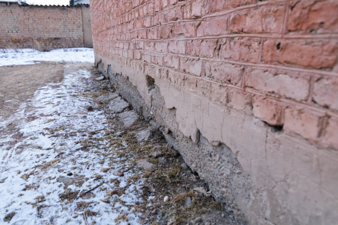 a brick wall that has been partially damaged by water