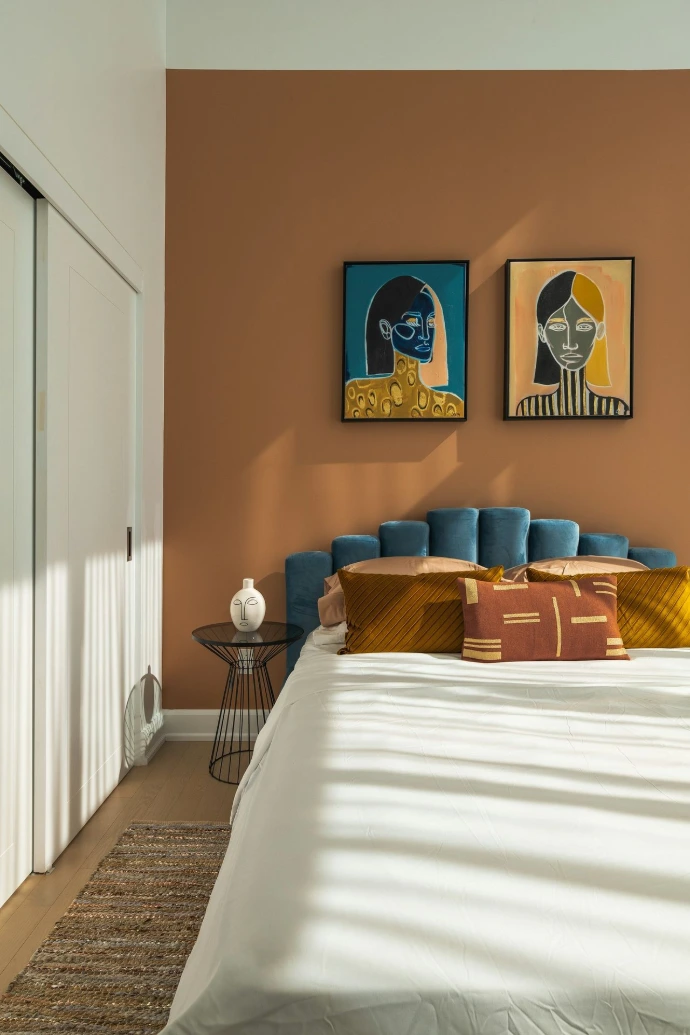 bedroom with painting hanging on painted wall