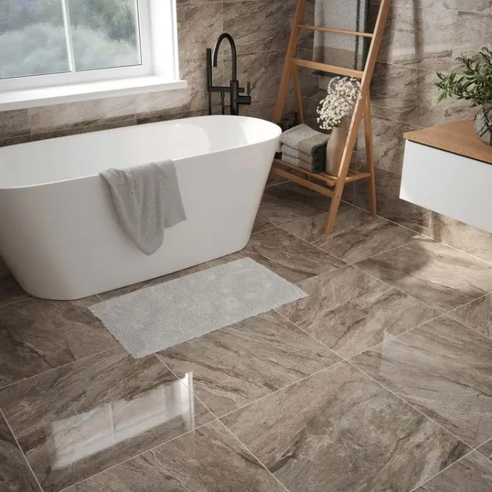 tiled bathroom space with tub and fixtures