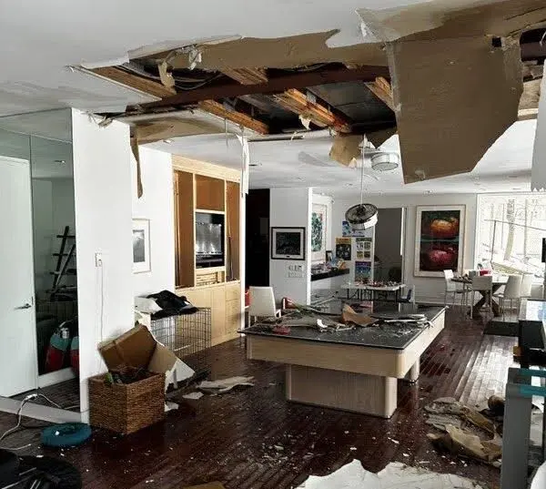 destroyed roof in living room due to water damage