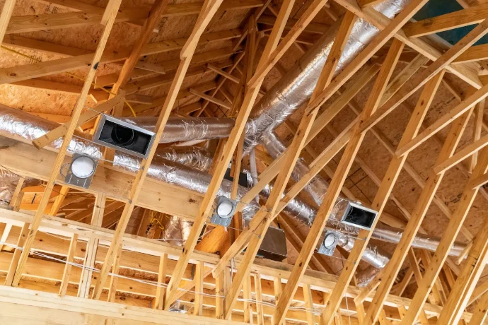 HVAC ductwork installed in exposed wood framing for heating, cooling, and ventilation system support
