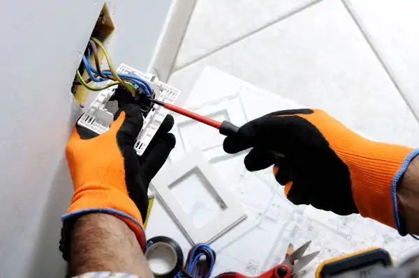 electrician working on power outlet